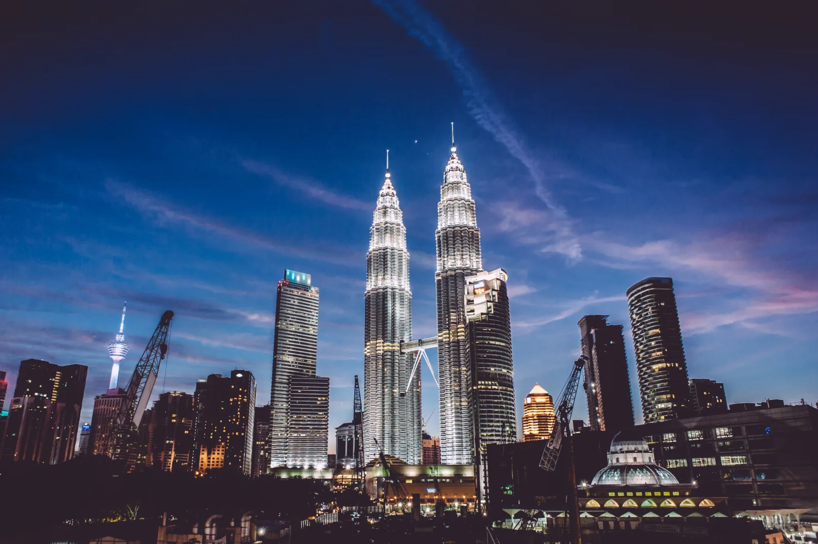 Petronas Twin Towers and the Kuala Lumpur city skyline at dusk